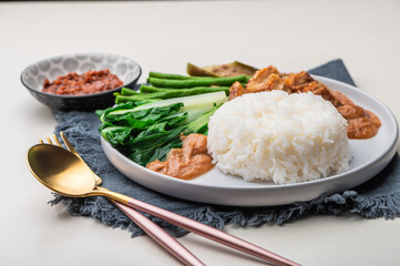 Crispy Pork Kare Kare (Peanut Sauce) with Vegetables and Shrimp Paste on the side 

