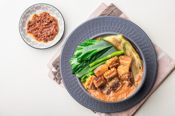 Crispy Pork Kare Kare (Peanut Sauce) with Vegetables and Shrimp Paste on the side 

