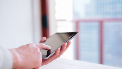 Fototapeta premium close up hands holding smartphone or digital tablet in concept of social media marketing online business and lyfestyle