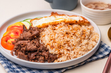 Tapsilog – a famous Filipino breakfast meal consisting of tapa, garlic fried rice, and fried egg. 