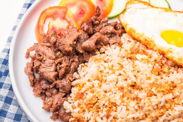 Tapsilog – a famous Filipino breakfast meal consisting of tapa, garlic fried rice, and fried egg. 