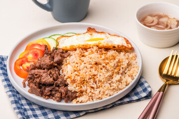 Tapsilog – a famous Filipino breakfast meal consisting of tapa, garlic fried rice, and fried egg. 