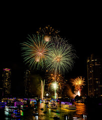 Firework show to celebrate of the new year 2024 along Chao Praya River with the night scene on Asiatique landmark side in Bangkok city, Thailand.