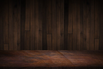 Empty space on a wooden table for product display with a blurred brown wooden wall background..