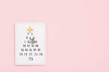 Christmas calendar on pink wall
