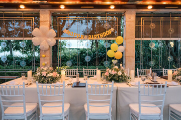 Setting up a banquet dining table for a birthday celebration, decor in restaurant