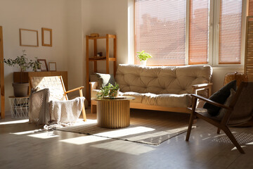 Interior of living room with sofa and armchairs