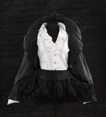 vintage black jacket and skirt with ruffles on a mannequin