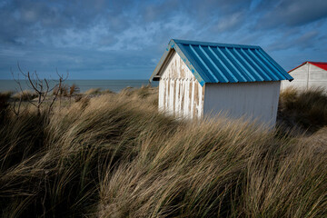 Gouville, France - 12 30 2023: View of colorful bathing wooden cabins of Gouville on the dunes.