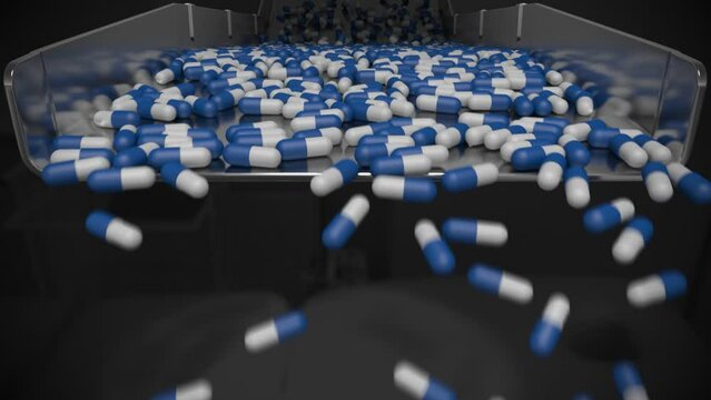 Medicine capsules tumbling off of a sorting tray in slow motion