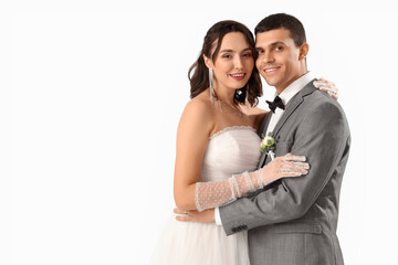 Young wedding couple hugging on white background