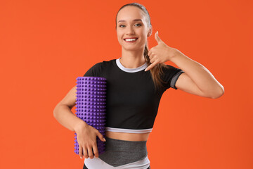 Female trainer with foam roller showing 