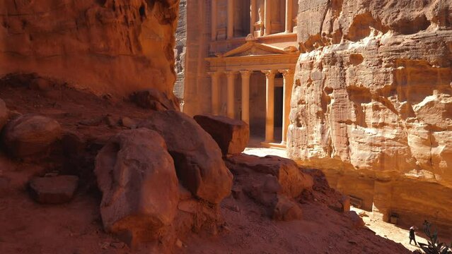 Walking around Petra the treasury in the Jordanian desert and the ancient city. Dunes and sandy rocks on background. Gimbal stabilized personal perspective point of view POV wide angle 4K