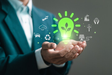 Green energy concept. businessman with light bulb and ESG icons for clean energy. World sustainable...