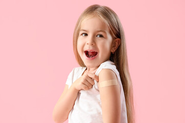 Little girl with patch after vaccination on pink background