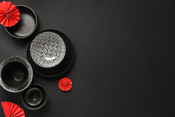 Bowl with decor on black background. Chinese table setting