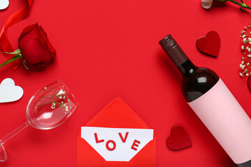 Frame made of bottle with wine, rose flower, glass and hearts on red background. Valentine's Day...