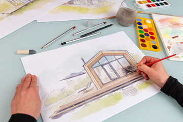 Architect illustrator working on hand drawn illustration of a modular prefabricated house  using...