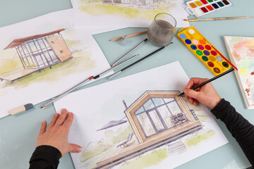 Architect illustrator working on hand drawn illustration of a modular house  using black pencil to draw lines on a sketch. - 701852154