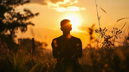 Möbelaufkleber Silhouette of a praying man against the background of sunrise © PhotoHunter