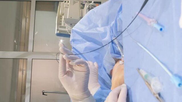 Phlebectomy is performed under general or spinal anesthesia. Surgeons work in the clinic. Vertical video