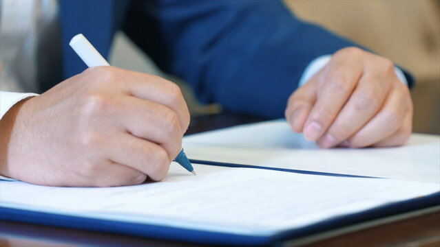 Business man signing a contract.
