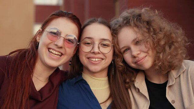 Three cheerful girls on the street