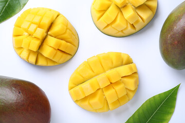 Ripe mangoes on white background, flat lay