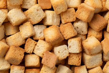 Fresh baked croutons for seasoning close up full frame as background