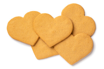 Heap of sweet cookies in heart shape isolated on white background close up
