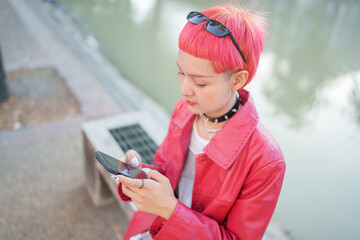Traveler girl using mobile phone on street in city Fashion gen z asian woman .Technology connection outdoor communication generation z modern lifestyle