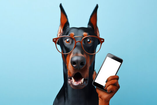 Shocked doberman dog in glasses holding smart phone mockup white screen over blue background. ai generative