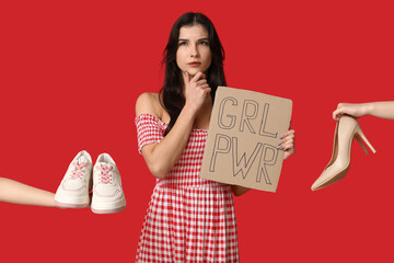 Thoughtful young woman with sign GRL PWR and shoes on red background. Feminism concept