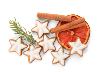 Composition with delicious stars shaped Christmas cookies, cinnamon, orange dried piece and fir tree branch on white background