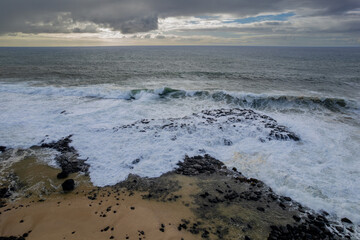 Aerial view of waves crashing on the rocky south coast of Mauritius island