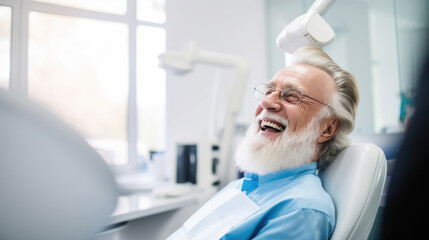 Elderly male patient with white hair is smiling and sitting in a dental chair - Powered by Adobe