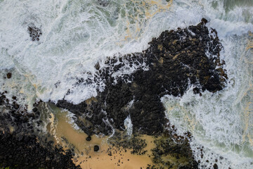 Aerial view of waves crashing on the rocky south coast of Mauritius island
