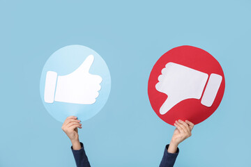 Little girl with like and dislike icons on blue background