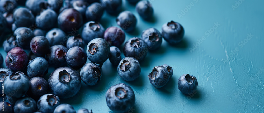 Canvas Prints A heap of fresh, ripe blueberries on a blue surface.