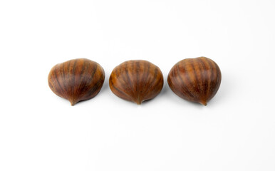 Edible chestnuts isolated on white background. Castanea sativa, the sweet or Spanish chestnut close up.