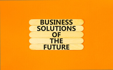 Business solutions of the future symbol. Concept words Business solutions of the future on wooden stick. Beautiful orange table orange background. Business solutions of the future concept. Copy space.