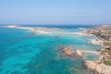 Obraz premium Elafonisi lagoon, Crete island Greece. Aerial drone view of turquoise water, beach with pink sand.