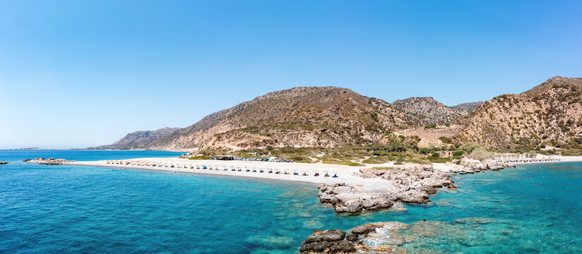 Crete Greece. Aerial drone view of pebble beach at Palaiochora, transparent crystal clear sea water.