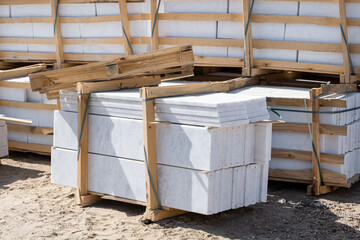 Pallets of marble, building material. Rock Blocks, Grey Shapes. New for use on construction site in...