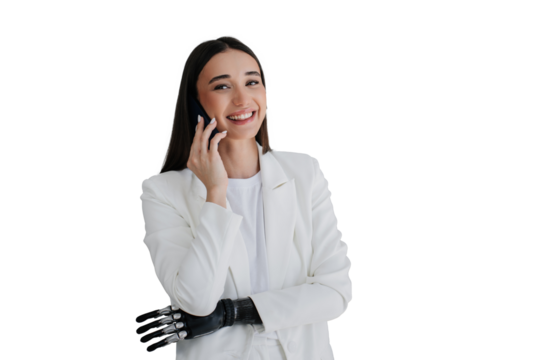 Cheerful gorgeous brunette girl with bionic hand talks by phone, smiling looks at camera at home. Toothy smiling young woman with artificial arm laughing. Mockup, cyber arm. Medicine and orthopaedics. - Powered by Adobe