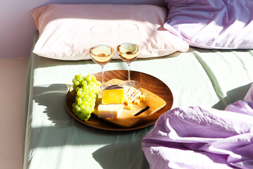 Wine and food on bed in sunny day