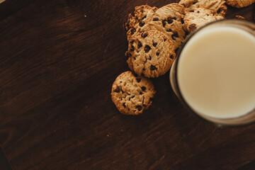 Savoring Simplicity: Homemade Cookies with a Glass of Milk on an Elegant Wooden Table.