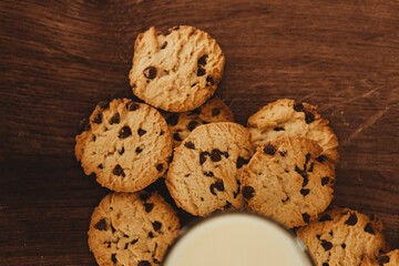Savoring Simplicity: Homemade Cookies with a Glass of Milk on an Elegant Wooden Table.