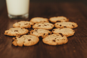 Savoring Simplicity: Homemade Cookies with a Glass of Milk on an Elegant Wooden Table.