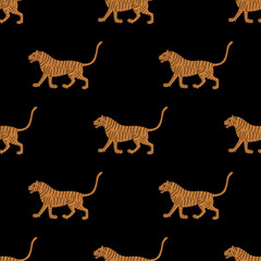 Seamless animal pattern with walking tigers. Traditional design from India. On black background.